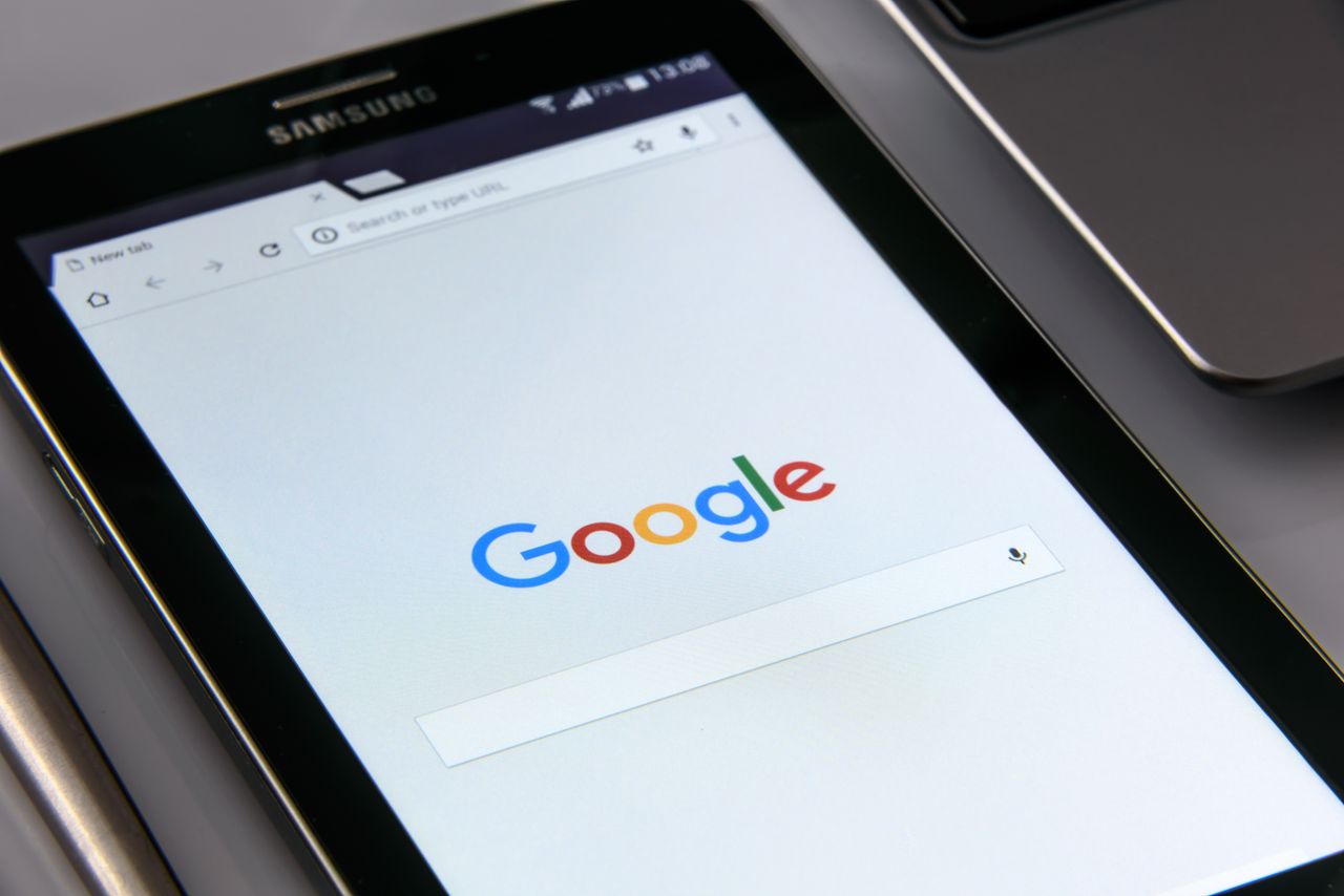 Services Close-up of a tablet displaying Google's search screen, emphasizing technology and internet browsing.